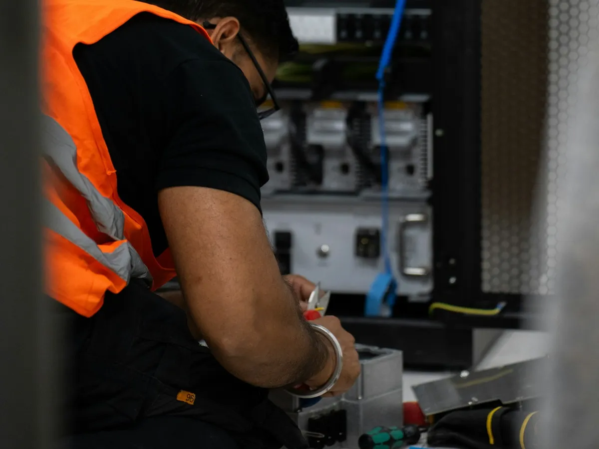 Technician servicing equipment in a server rack