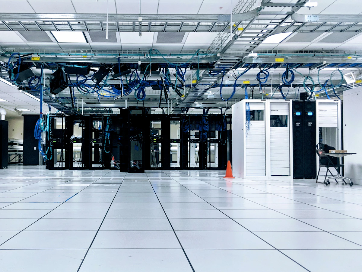 Raised-floor equipment room with rack cabinets and overhead cable trays