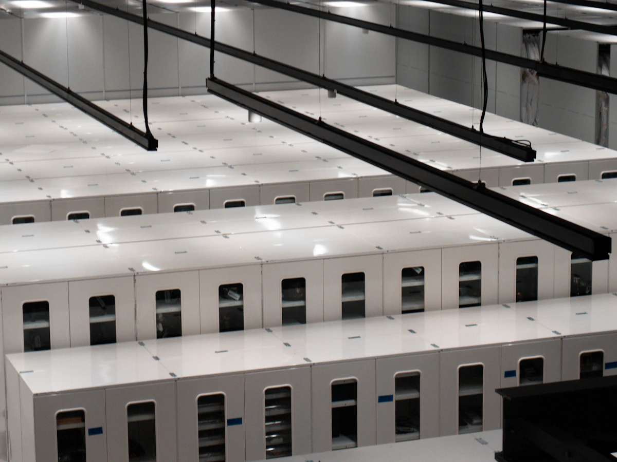 Rows of white server cabinets in a bright data centre